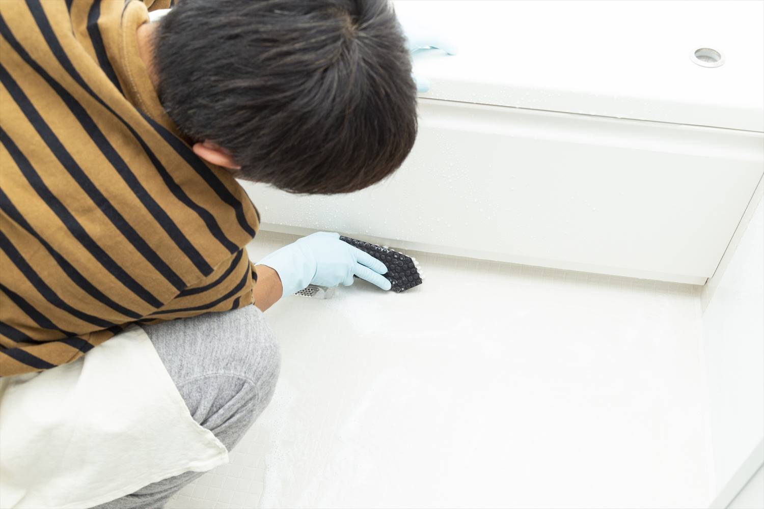 お風呂のカビ取りをする男性